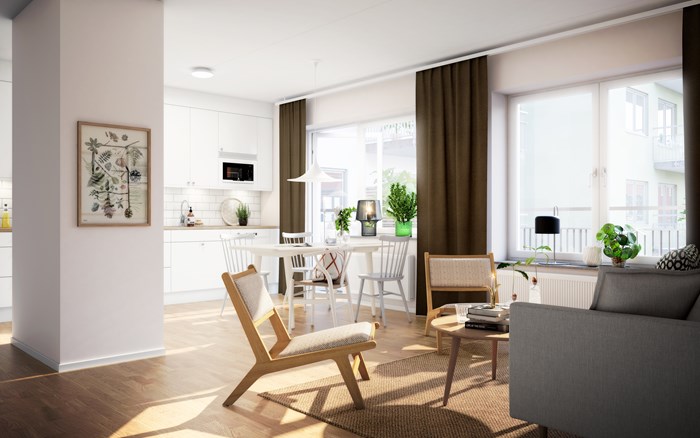 Interiör från en nyproducerad bostadsrätt, ett vardagsrum med generösa fönster där solen lyser in.